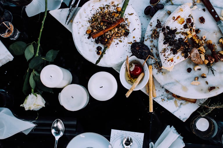 A beautifully arranged dinner table with appetizing dishes and decorative elements, perfect for a festive occasion.