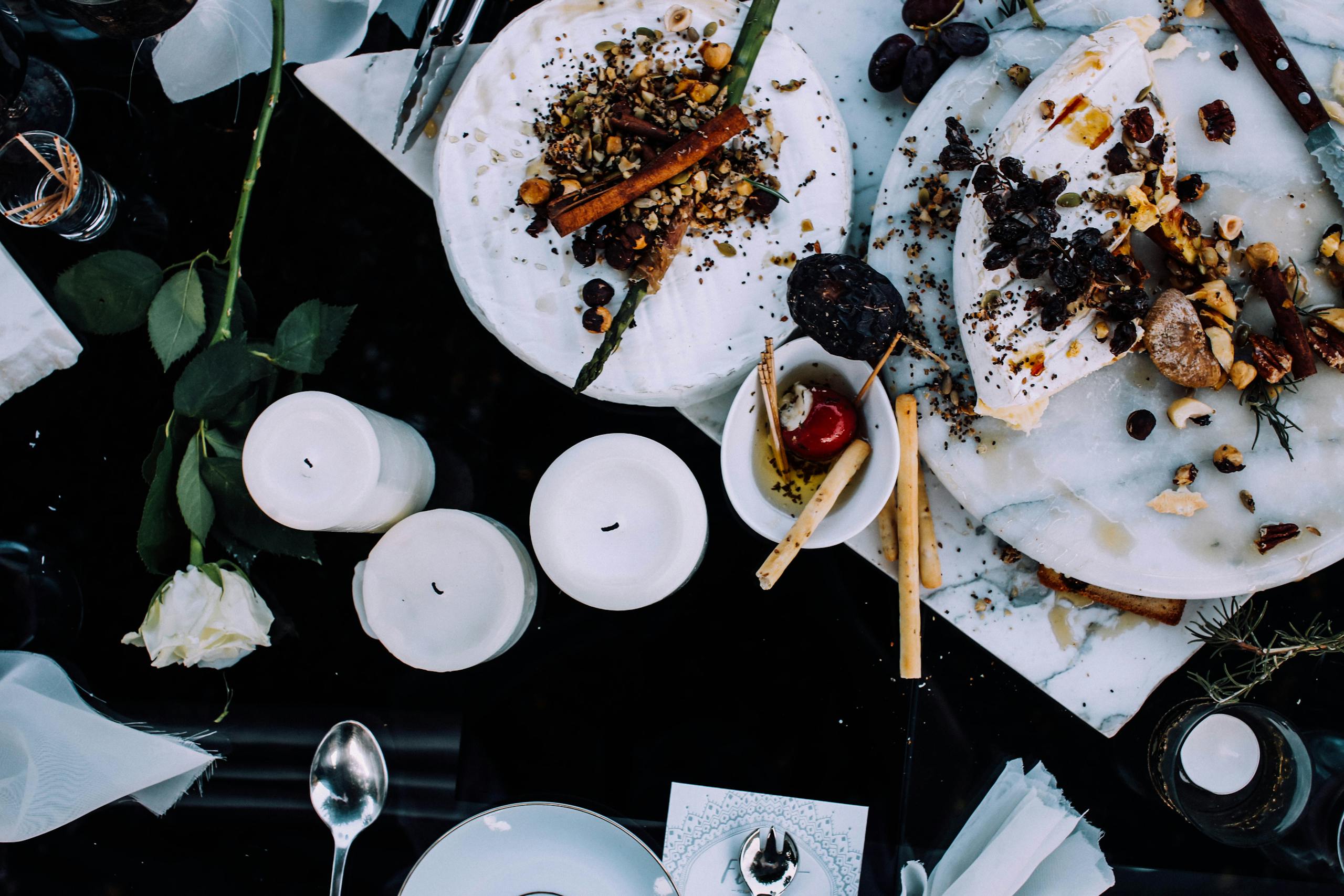 A beautifully arranged dinner table with appetizing dishes and decorative elements, perfect for a festive occasion.